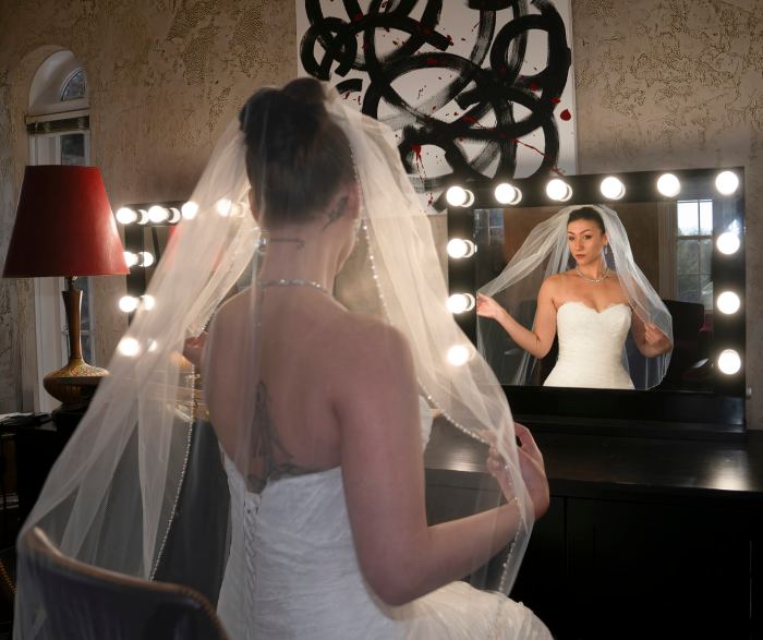 Bride beneath her veil among glowing lights at a Nashville venue