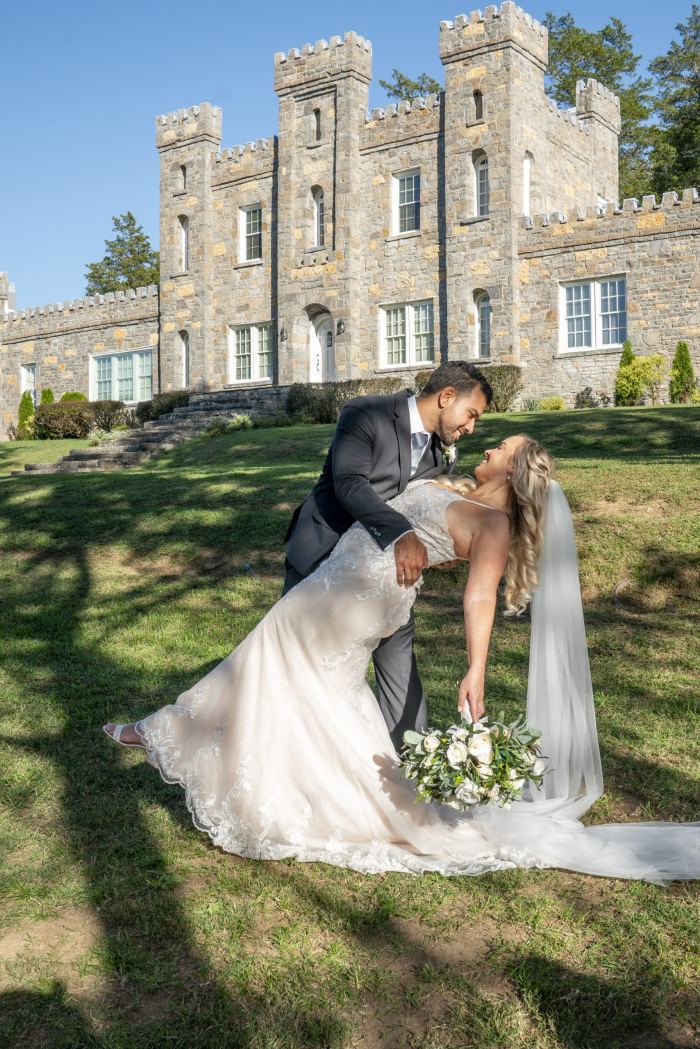 Bride with a flowing train on castle grounds near Nashville