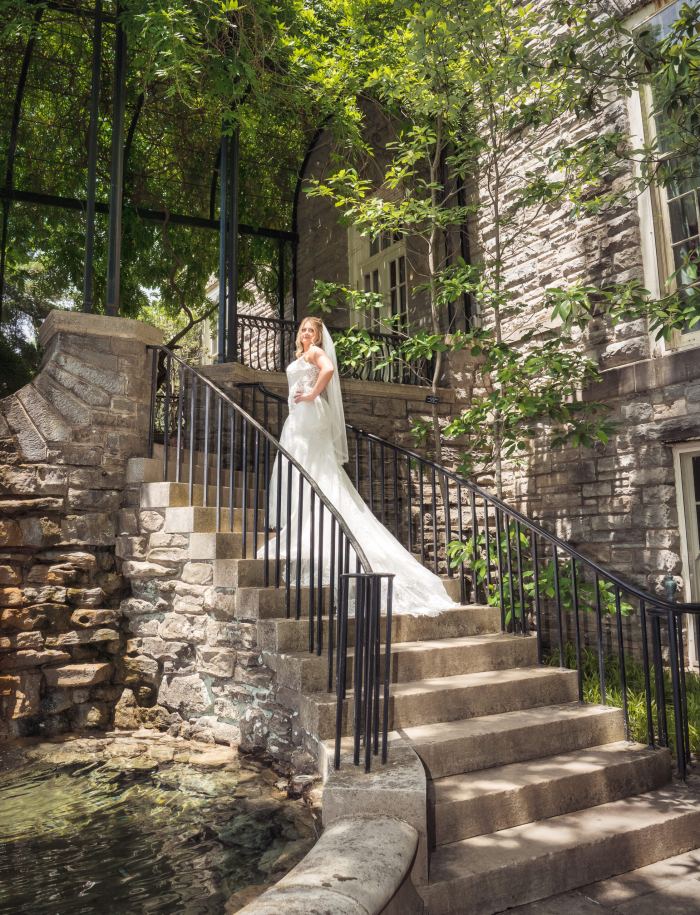 Bride on a grand stone staircase at a Nashville garden venue