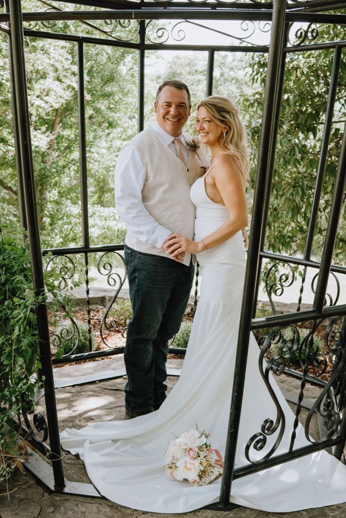 Bride and groom inside an iron garden gazebo near Nashville