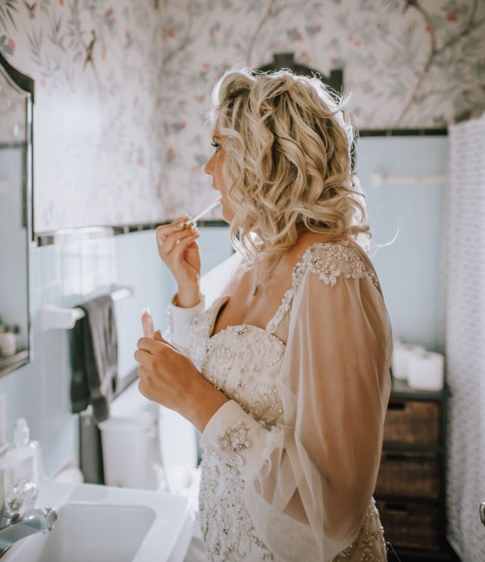 Bride preparing for her Nashville elopement by a rustic window