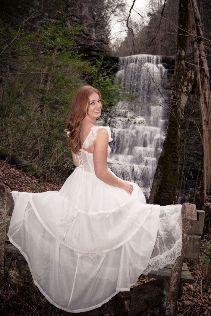 Bride twirls her gown at a private waterfall near Nashville