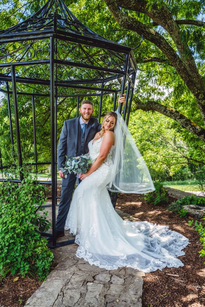 Couple beneath a garden gazebo at a Nashville estate elopement