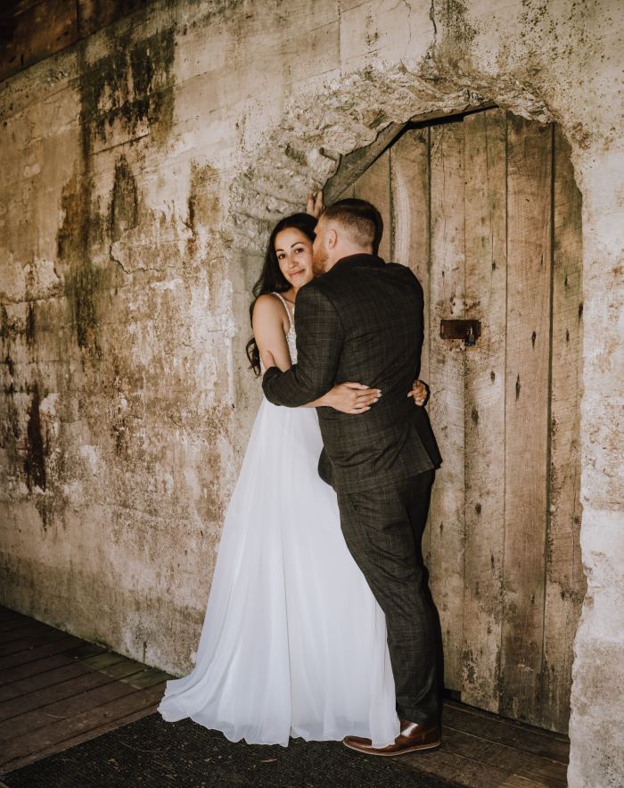 Couple embrace in a stone archway at a Nashville elopement