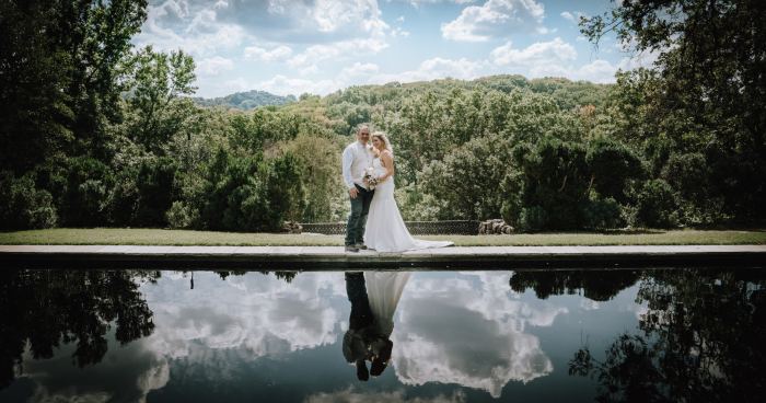 Couple framed by a sweeping Tennessee waterfall landscape