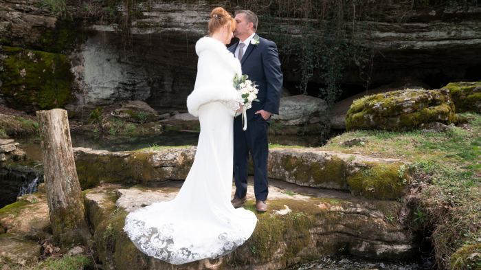 Couple kiss beside a Tennessee creek and waterfall