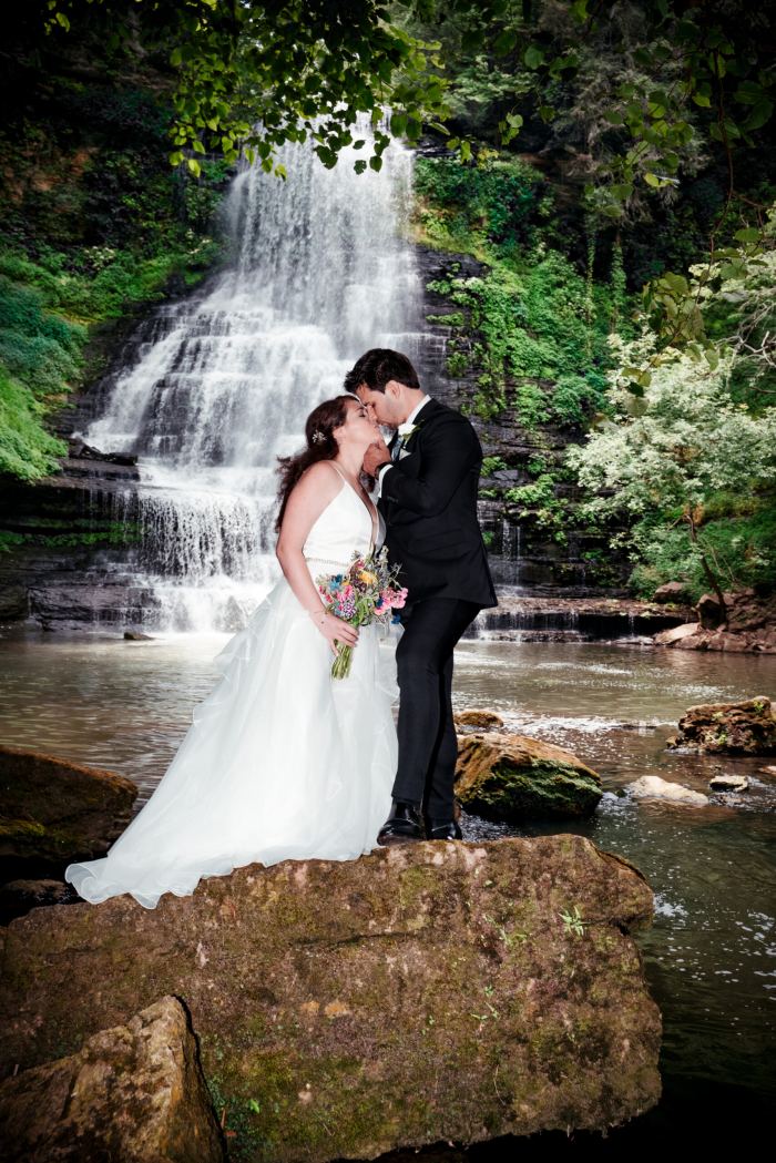 Couple on the rocks before a private Tennessee waterfall