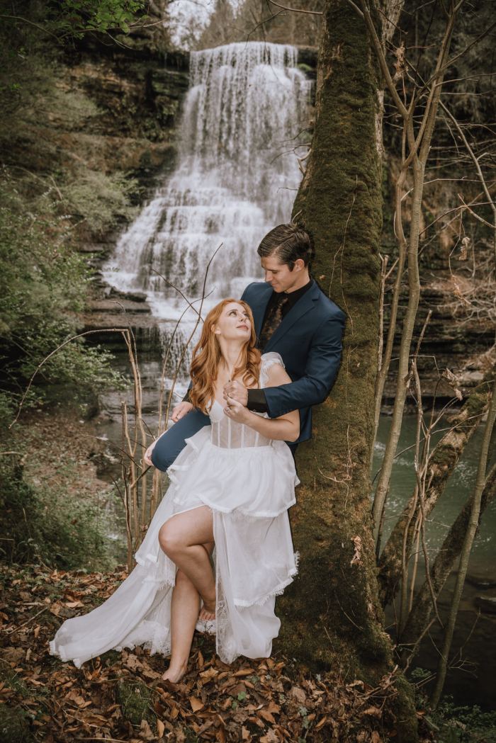 Couple at a tall woodland waterfall in Tennessee