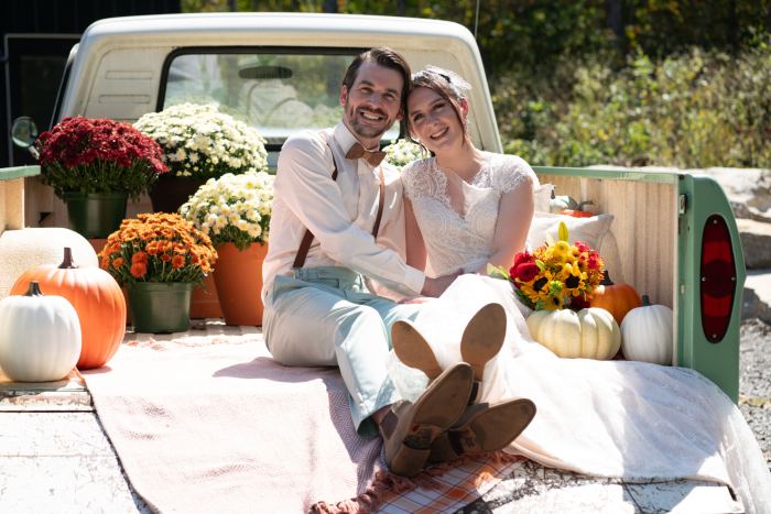 Couple in a vintage pickup truck at an autumn Nashville elopement