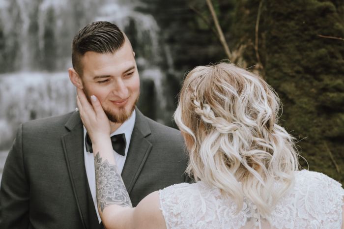 Groom and bride share a quiet moment at a Tennessee waterfall elopement
