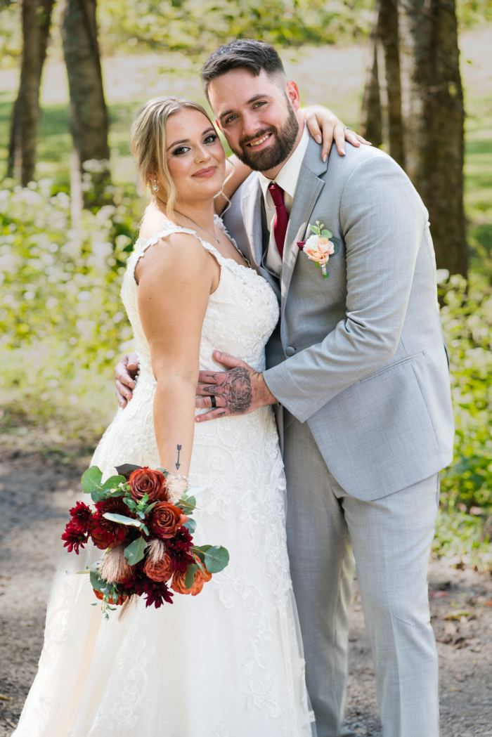 Joyful couple with a bouquet at a woodland Nashville elopement