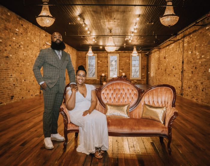 Newlyweds on a vintage sofa at Chateau on the Row on Music Row